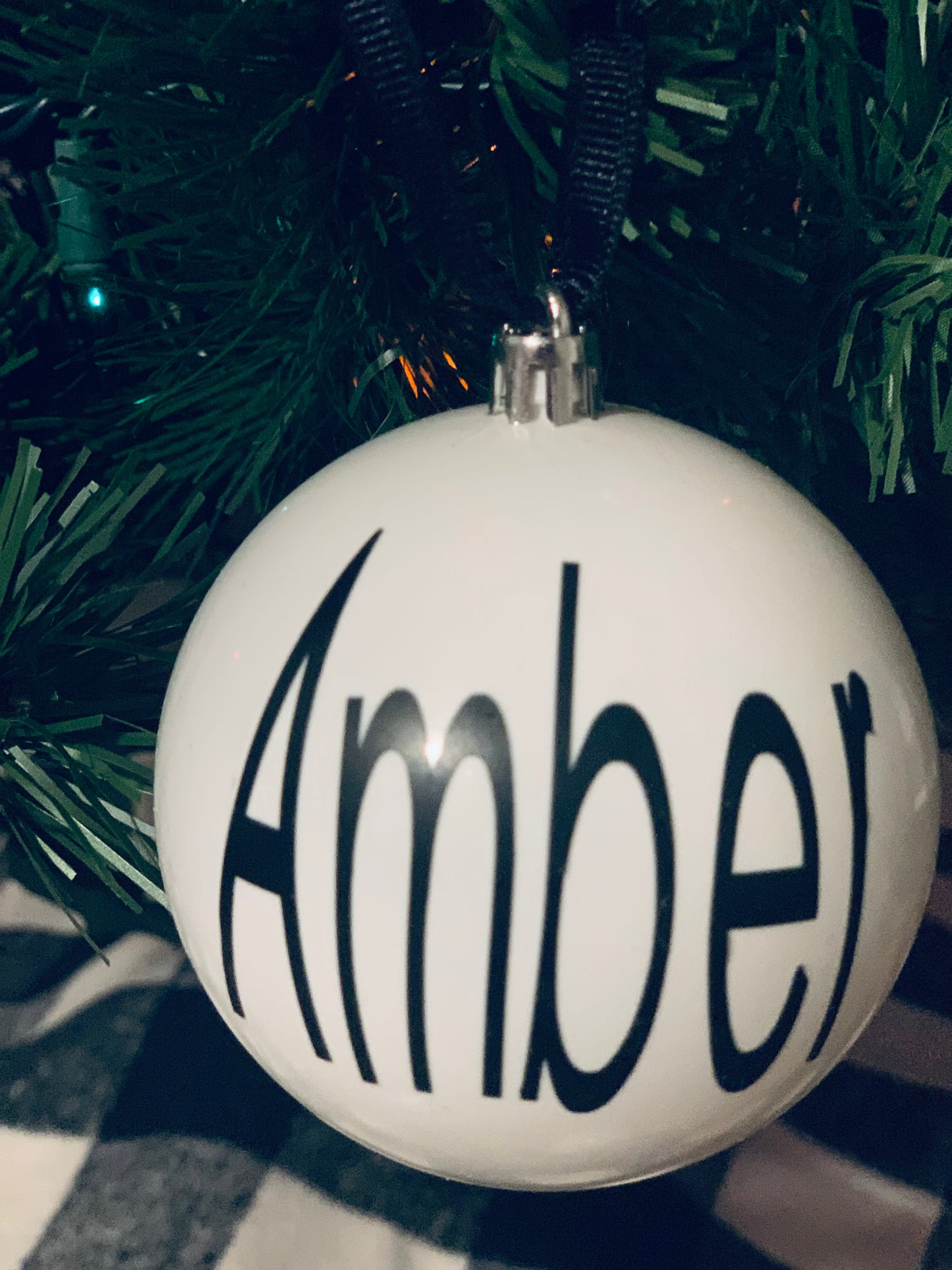 Large plastic ornaments with vinyl of personalized names.