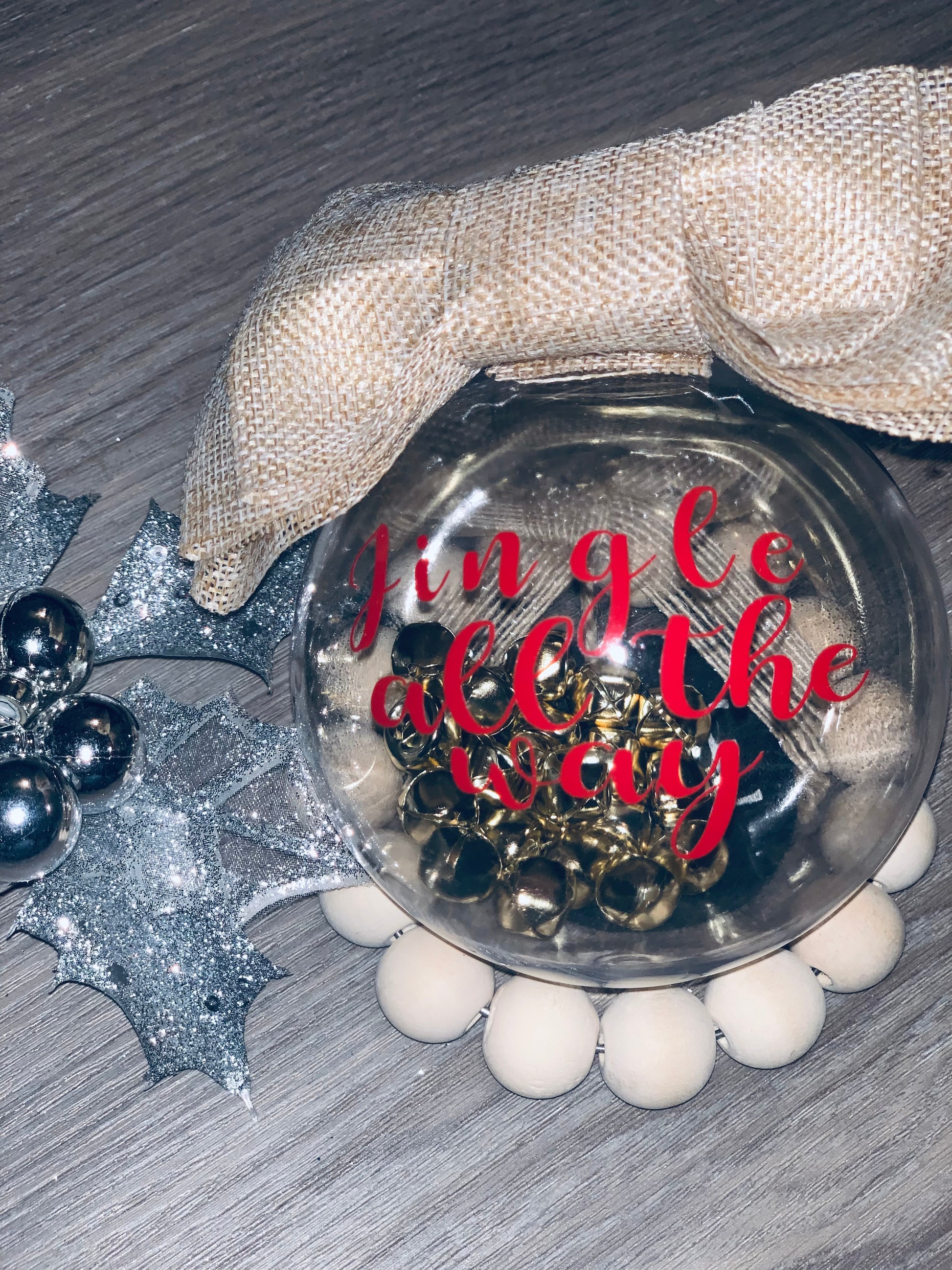 Large plastic ornament with jingle bells inside and saying of Jingle all the way.