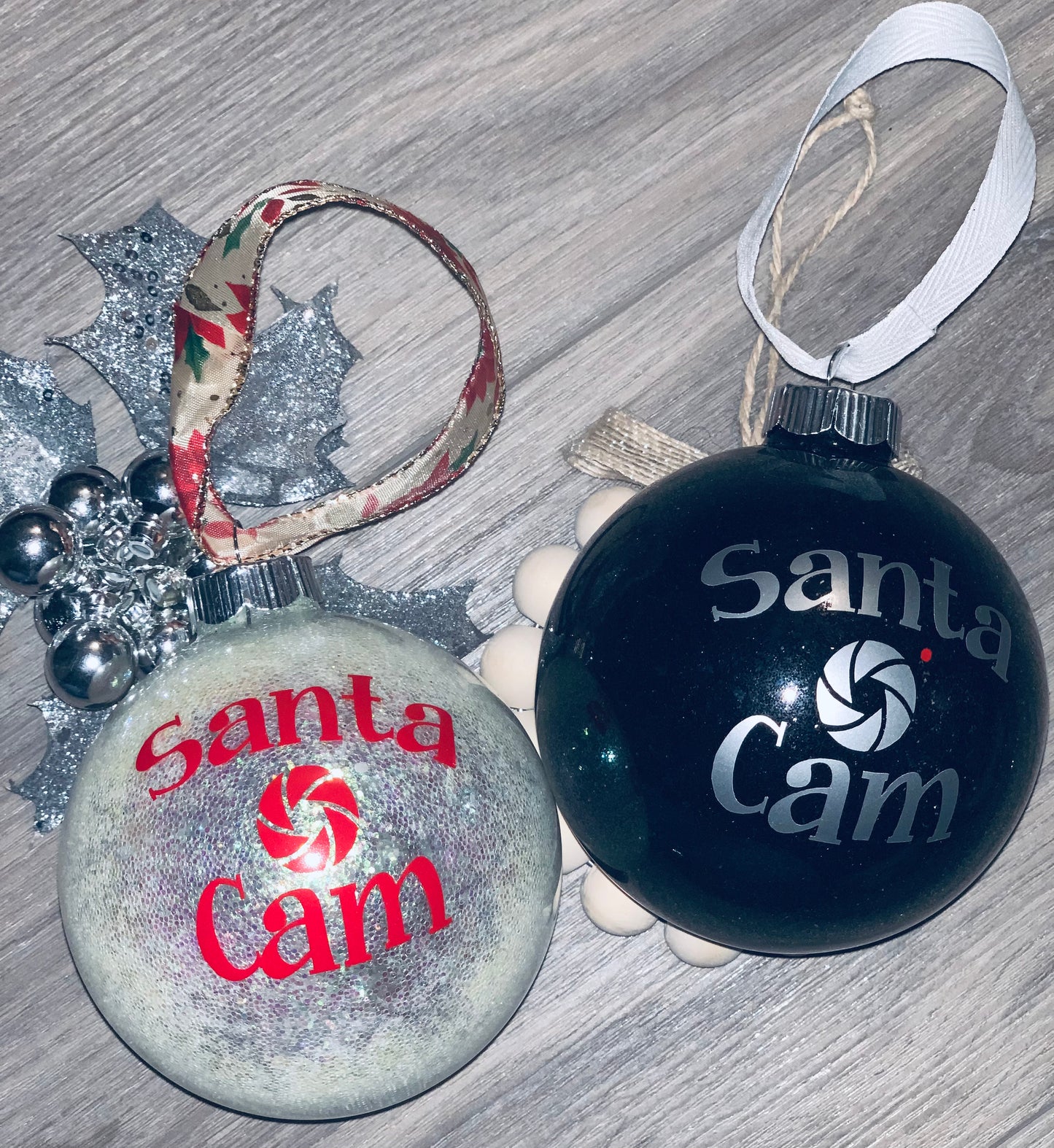 Large glass ornaments saying Santa Cam